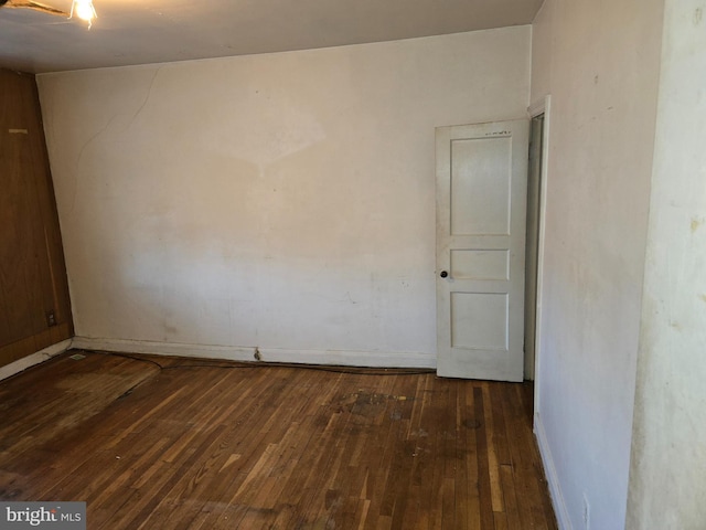 unfurnished room with dark wood-style floors