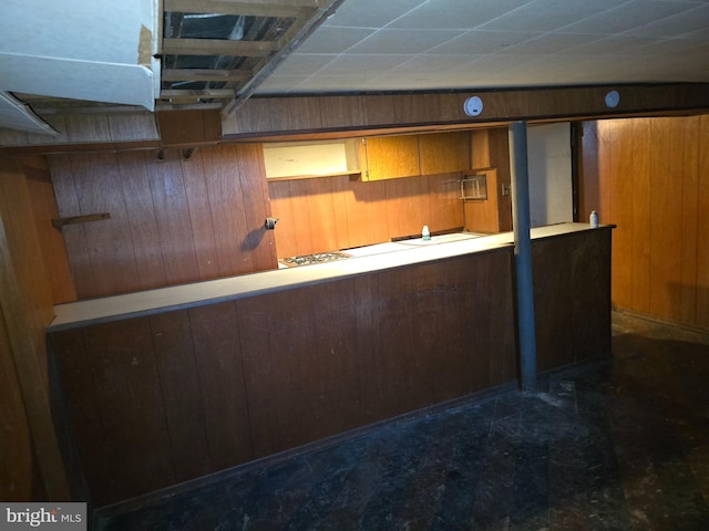 bar featuring dark floors and wooden walls