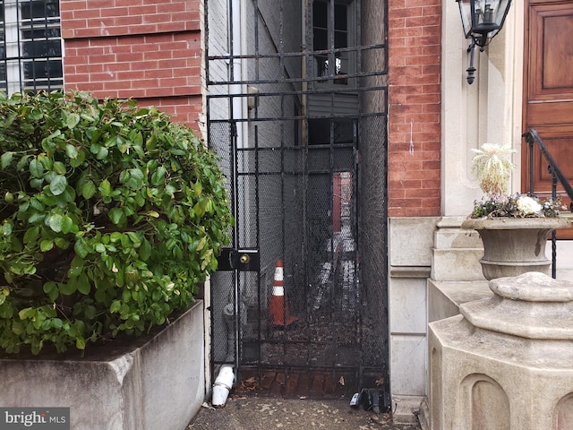 doorway to property featuring brick siding