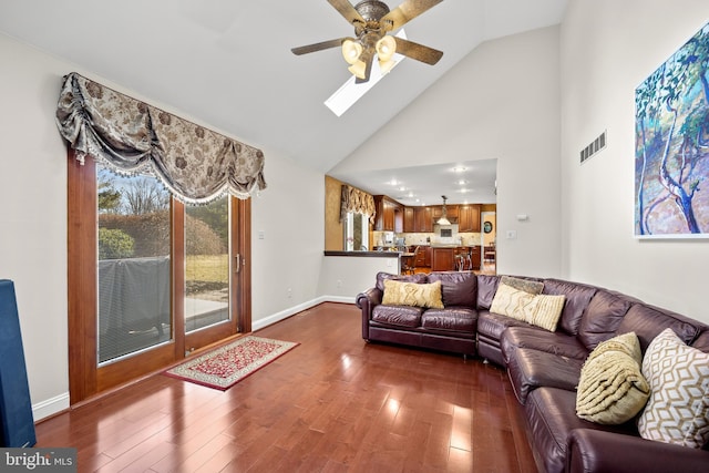 living room with a skylight, baseboards, visible vents, and dark wood finished floors