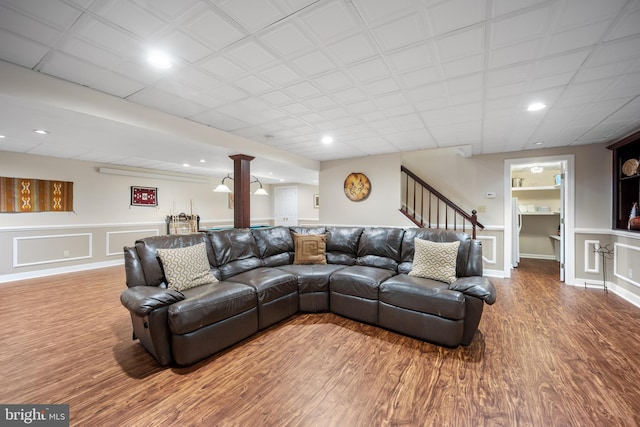 living room with stairs, wood finished floors, and recessed lighting