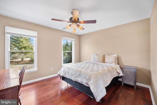 bedroom featuring dark wood-style floors, baseboards, and a ceiling fan