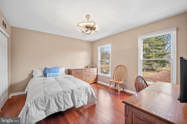 bedroom featuring dark wood-style floors and baseboards