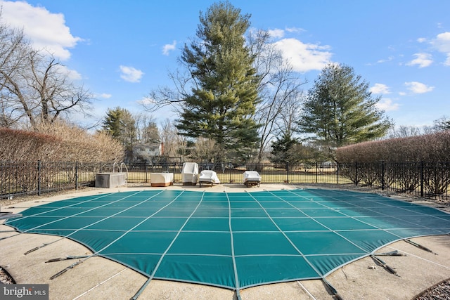 view of swimming pool featuring a patio, fence, and a fenced in pool