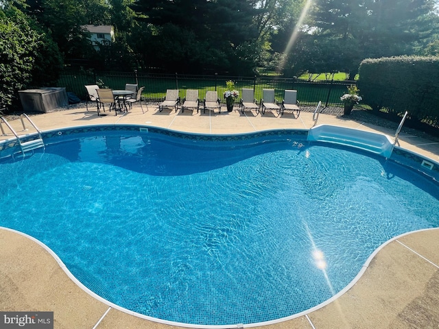 view of swimming pool with a patio area, fence, and a fenced in pool