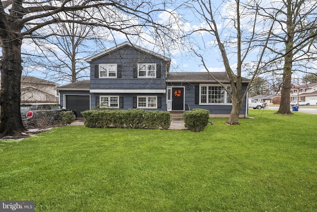 split level home with a garage and a front yard