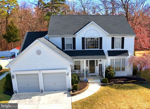 traditional-style home with a porch, an attached garage, a shingled roof, concrete driveway, and a front lawn