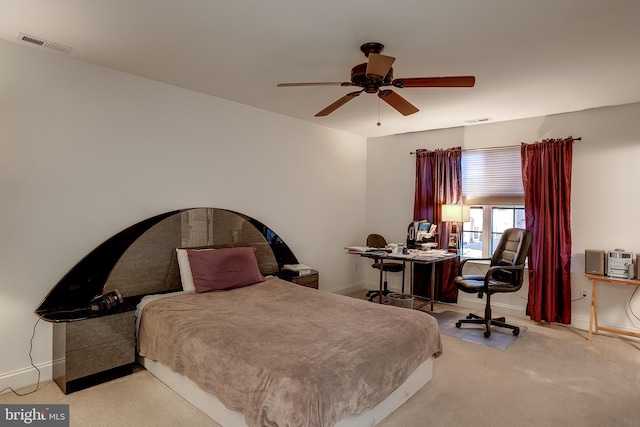 bedroom with light colored carpet, visible vents, and baseboards