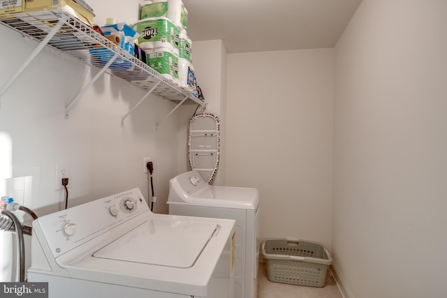 clothes washing area featuring laundry area and washer and clothes dryer