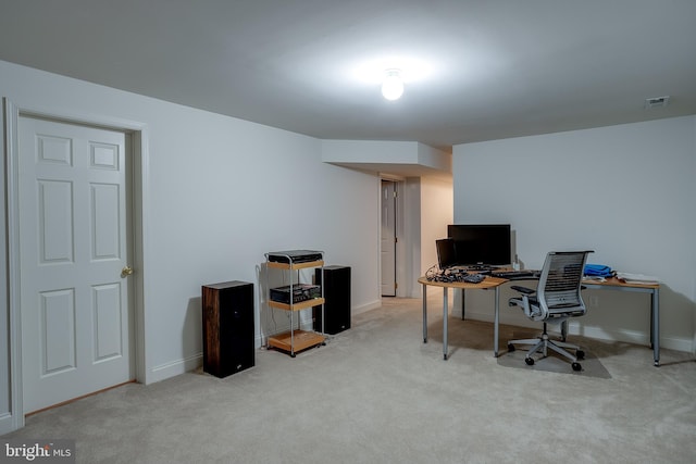 office space featuring baseboards, visible vents, and light colored carpet