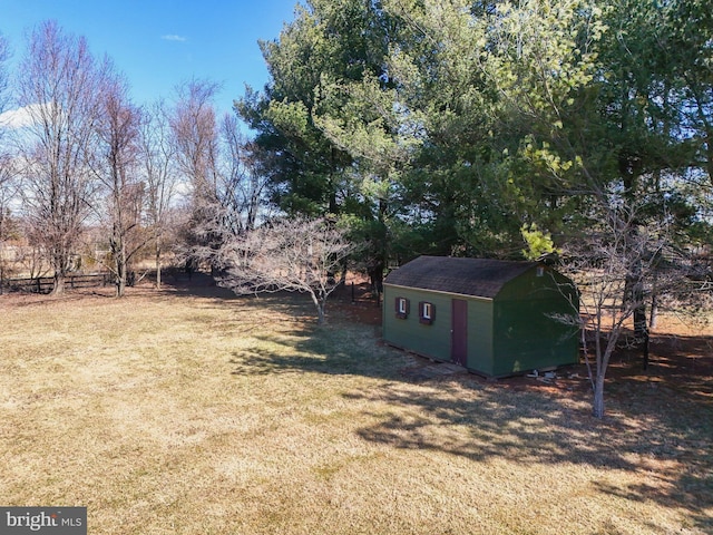 view of yard featuring a storage shed and an outbuilding