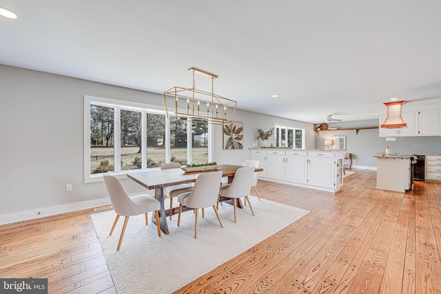 dining room featuring light wood finished floors, baseboards, a chandelier, and recessed lighting