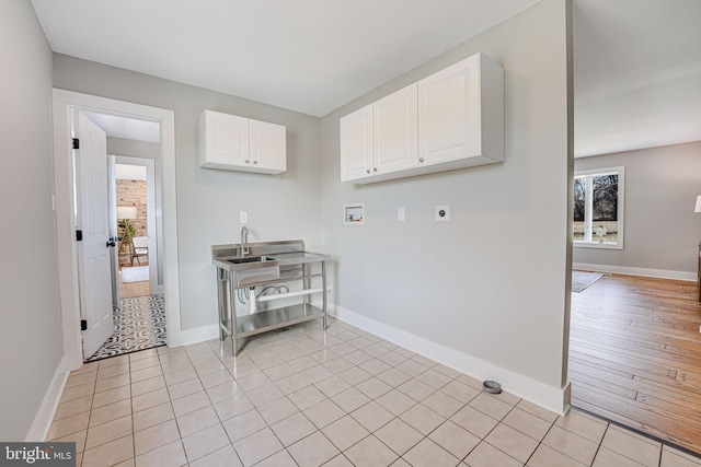 washroom with cabinet space, baseboards, washer hookup, and electric dryer hookup