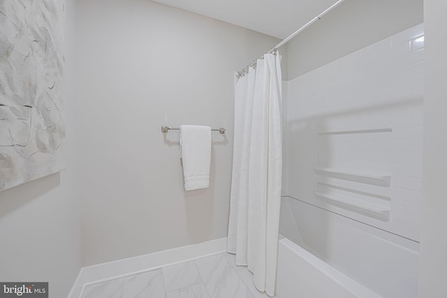 full bathroom featuring marble finish floor and baseboards