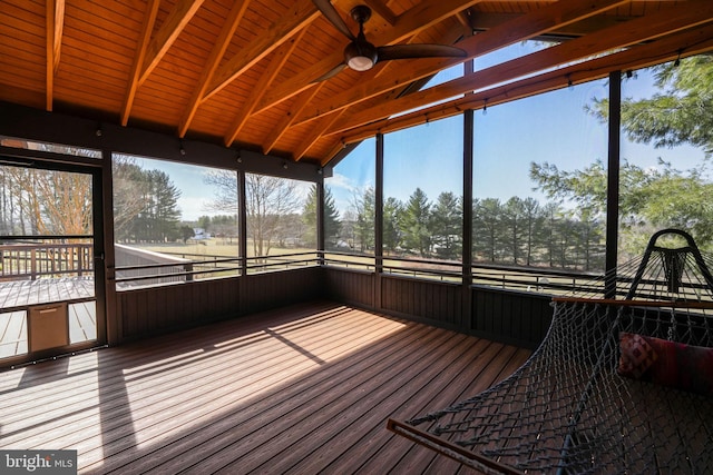 unfurnished sunroom with lofted ceiling with beams and a ceiling fan