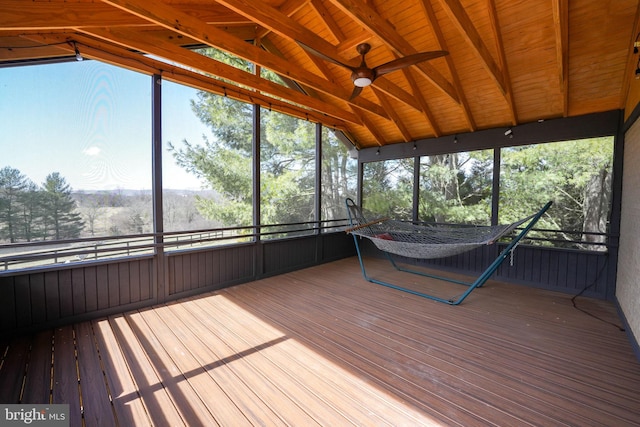 unfurnished sunroom with vaulted ceiling with beams and ceiling fan