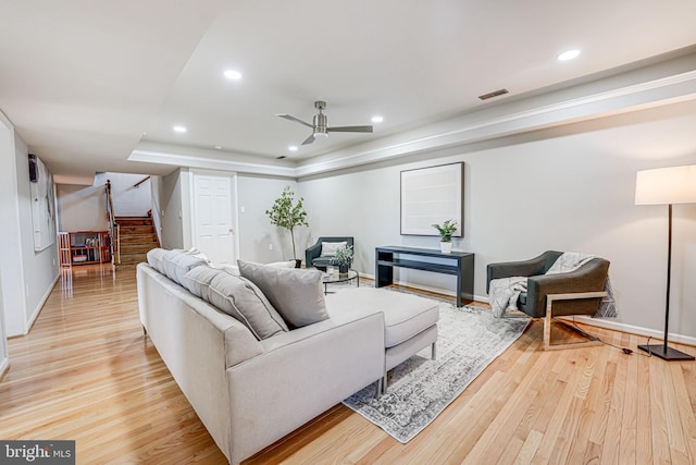 living area with light wood-style flooring, visible vents, stairway, and recessed lighting