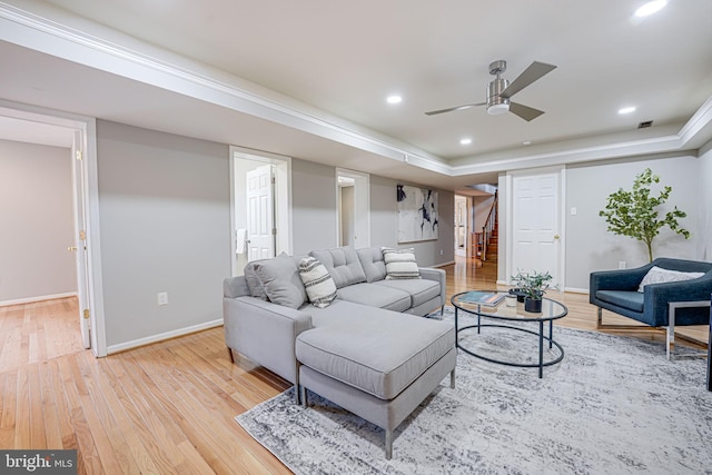 living room featuring light wood-type flooring, stairway, baseboards, and recessed lighting