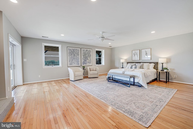 bedroom with multiple windows, recessed lighting, hardwood / wood-style flooring, and baseboards