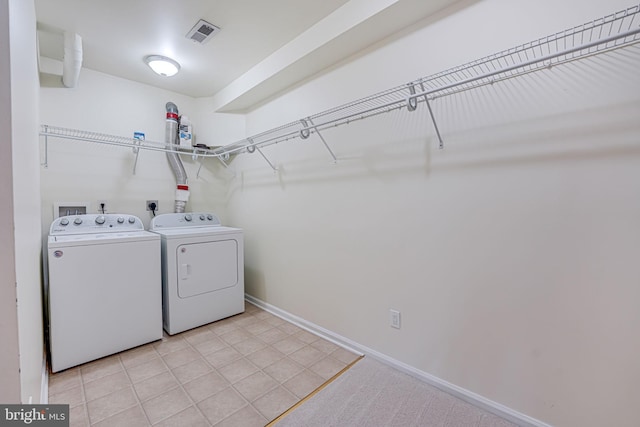 laundry room featuring light tile patterned floors, visible vents, laundry area, independent washer and dryer, and baseboards