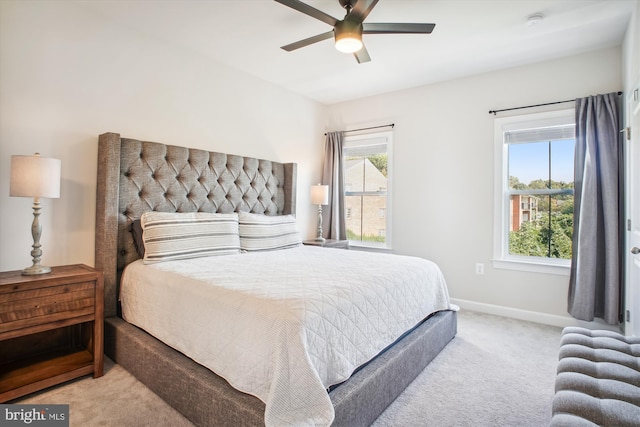 bedroom featuring ceiling fan, multiple windows, baseboards, and carpet flooring