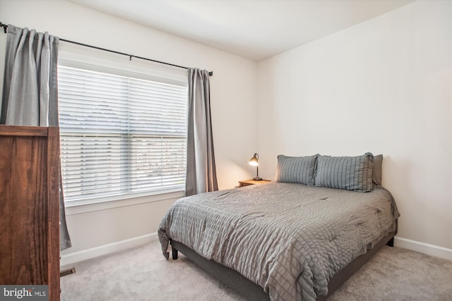 bedroom featuring carpet flooring, visible vents, and baseboards