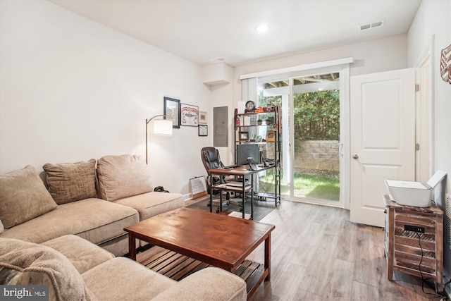 living area featuring light wood-type flooring and visible vents