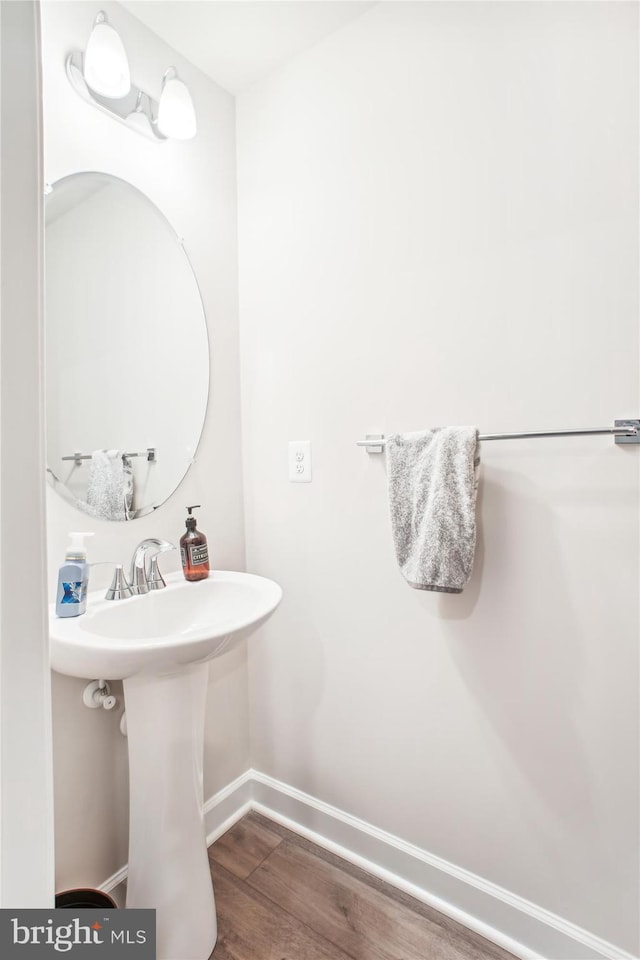 bathroom with baseboards and wood finished floors