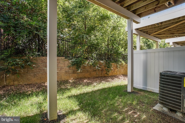 view of yard with fence and central AC unit