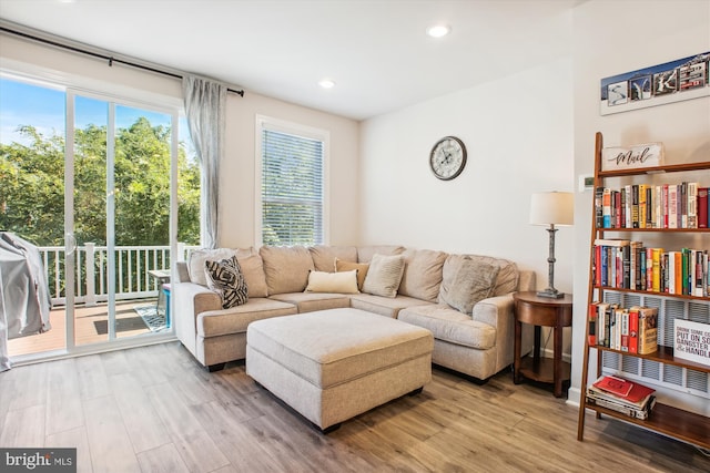 living room with wood finished floors and recessed lighting