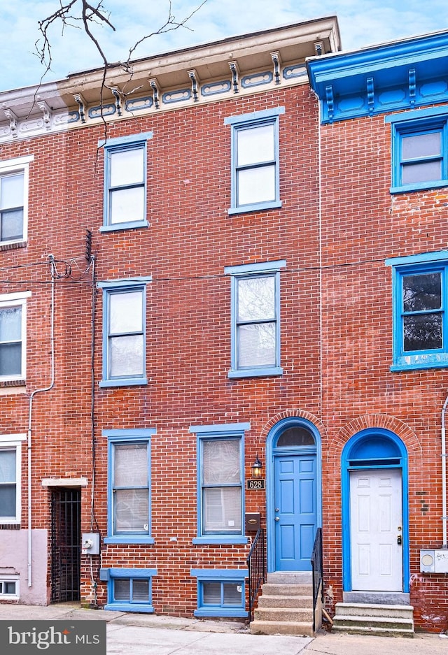 view of front of property featuring entry steps and brick siding