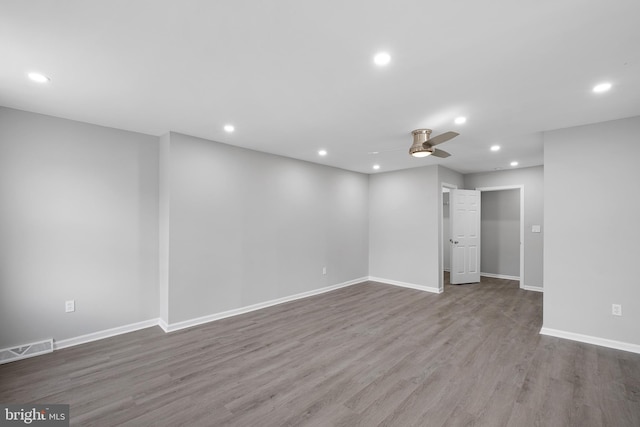 unfurnished room featuring a ceiling fan, wood finished floors, visible vents, and recessed lighting