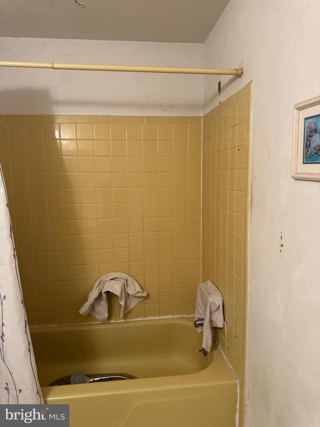 bathroom featuring shower / bath combination with curtain