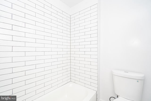 bathroom with bathtub / shower combination and toilet