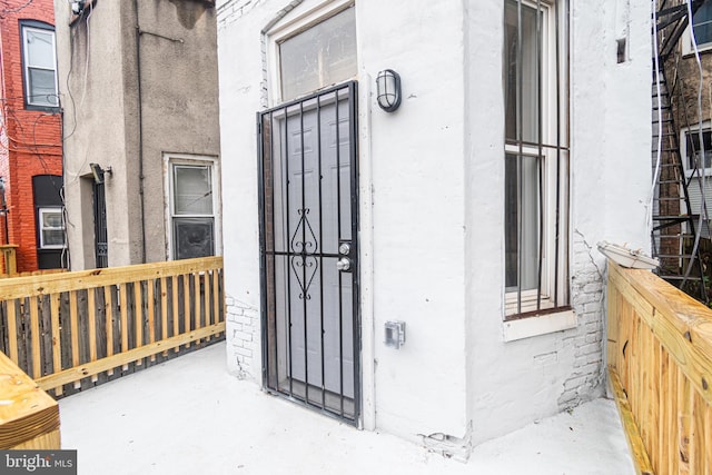 property entrance with stucco siding