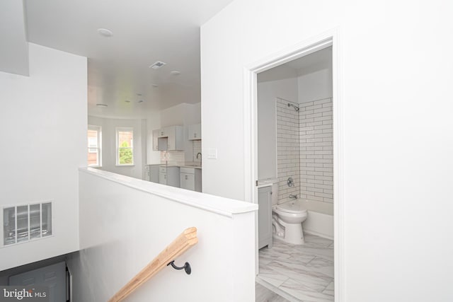 full bathroom with marble finish floor, visible vents, shower / bathing tub combination, and toilet