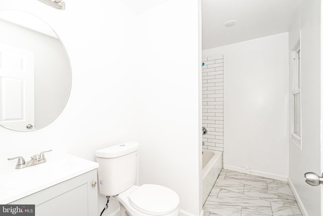 bathroom featuring marble finish floor, baseboards, vanity, and toilet