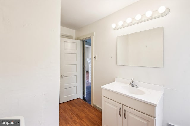 bathroom with wood finished floors and vanity