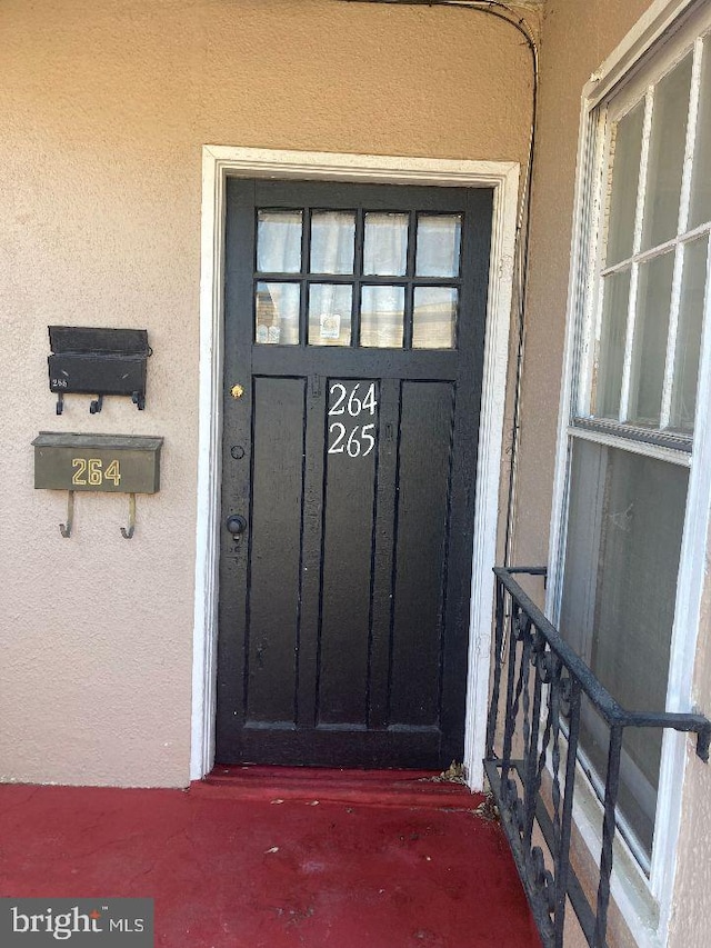 entrance to property with stucco siding