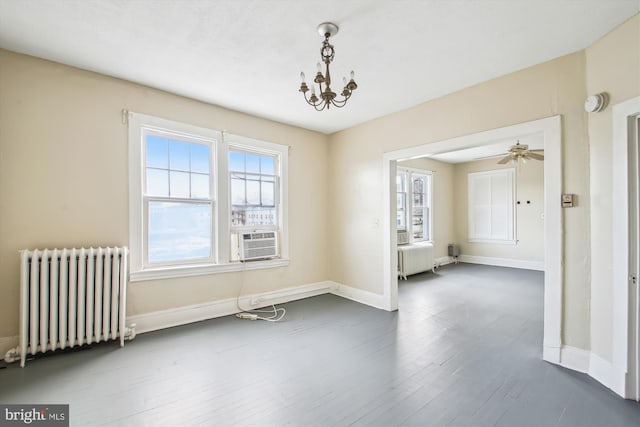 unfurnished room with baseboards, dark wood-style flooring, cooling unit, and radiator