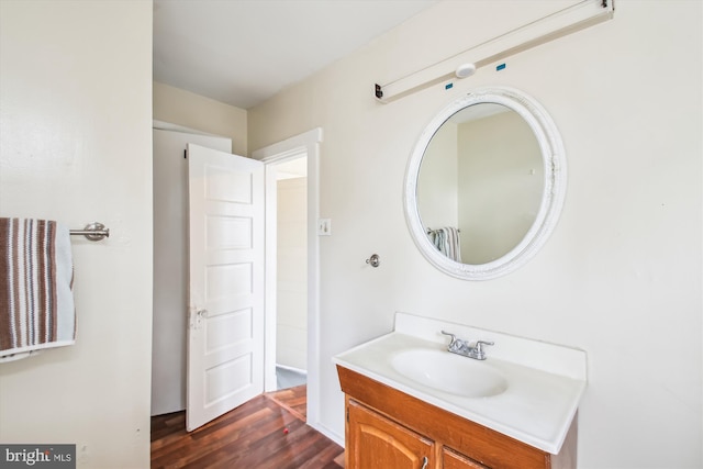 bathroom with wood finished floors and vanity