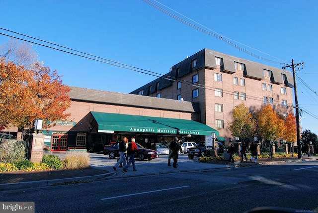 view of building exterior with uncovered parking