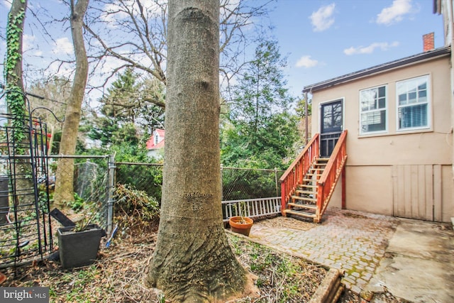 view of yard with stairway and fence