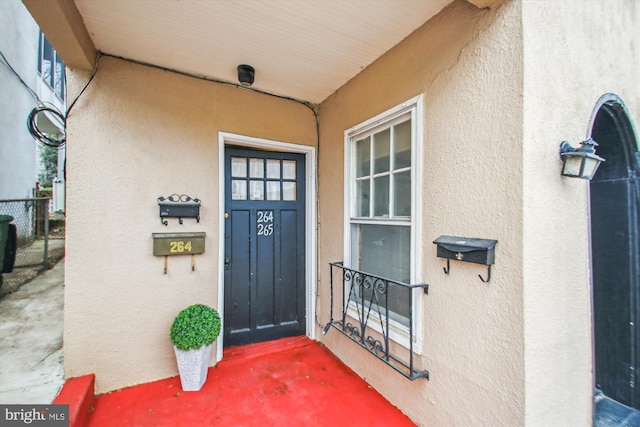 entrance to property with stucco siding