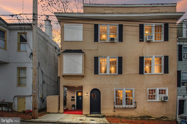 view of front of house with cooling unit and stucco siding