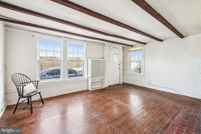 entrance foyer featuring beam ceiling and wood-type flooring