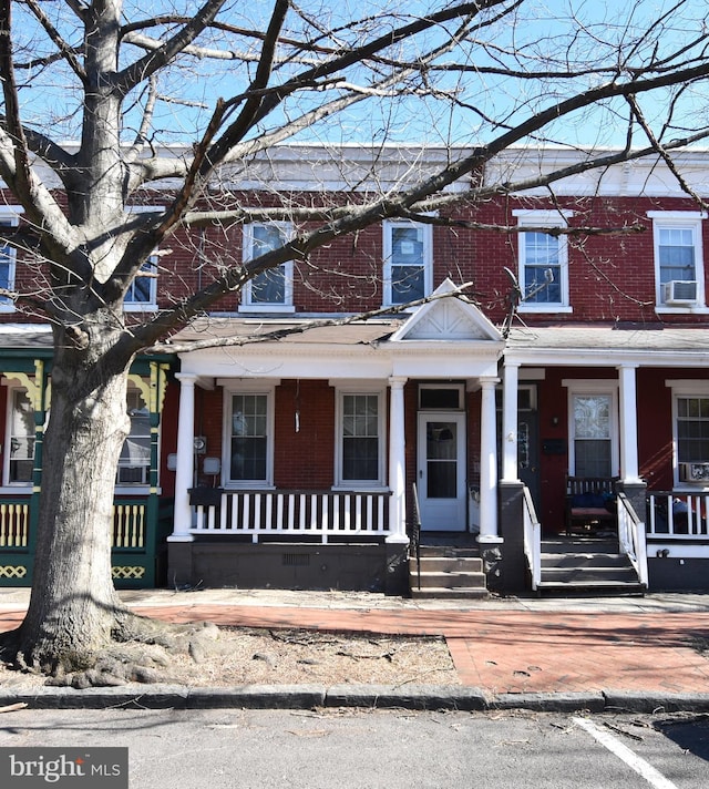 multi unit property featuring cooling unit and brick siding