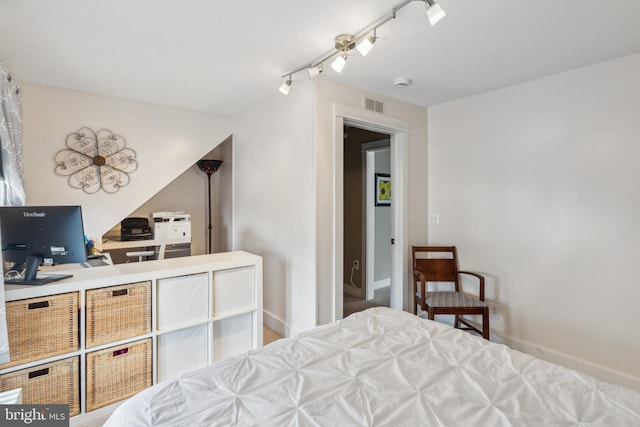 bedroom with rail lighting and visible vents