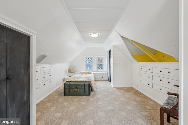 carpeted bedroom featuring vaulted ceiling