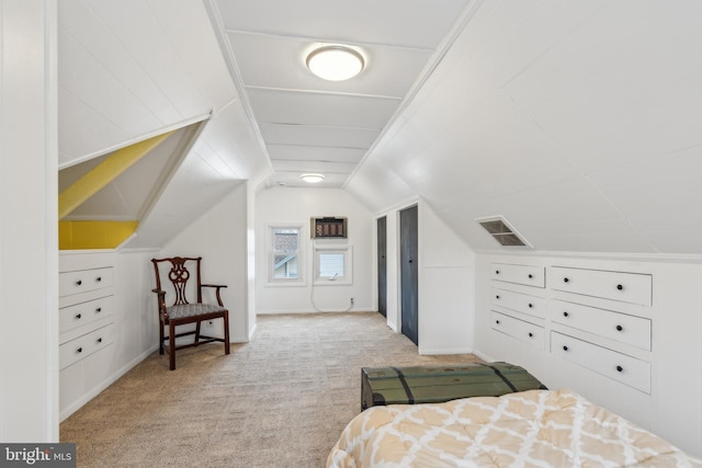 carpeted bedroom with lofted ceiling and visible vents